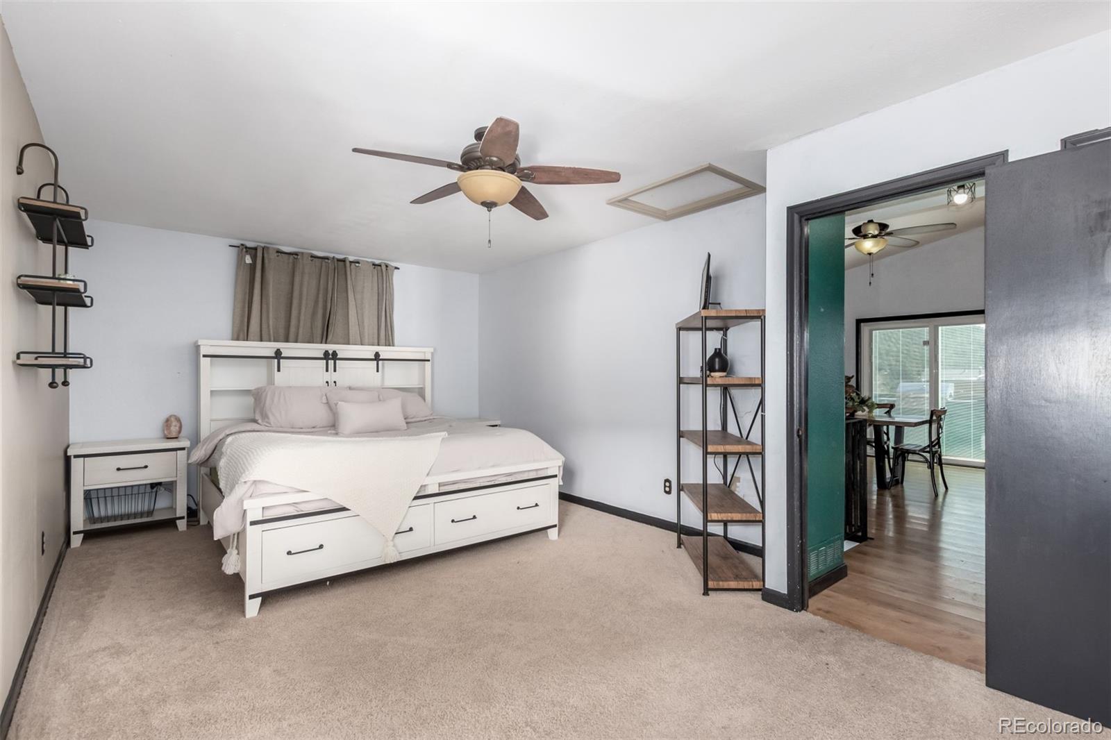 121 Sunlight Lane Bailey, CO 80421 - Photo 13 of 30 a bedroom with a bed and a chandelier