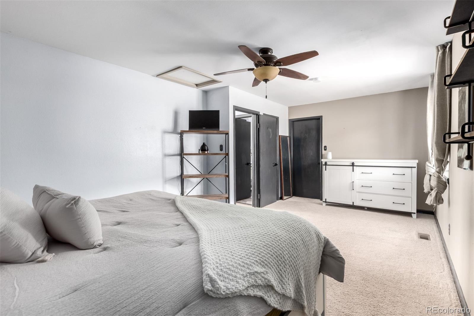 121 Sunlight Lane Bailey, CO 80421 - Photo 14 of 30 a bedroom with a bed and a chandelier