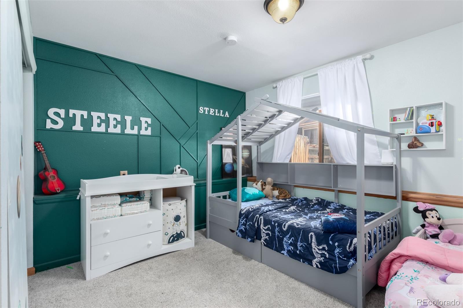 121 Sunlight Lane Bailey, CO 80421 - Photo 22 of 30 a bedroom with a bed and a chandelier