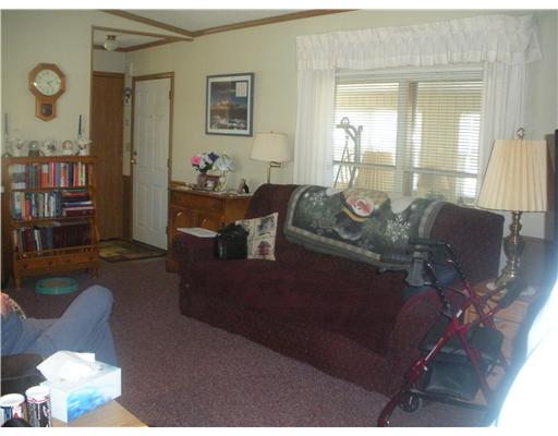 36 Lane F Coventry, RI 02816 - Photo 5 of 12 Living Room. Living Room facing toward Kitchen (you can see the sunny Florida Room through the windows). PERGO floor underneath the carpet!