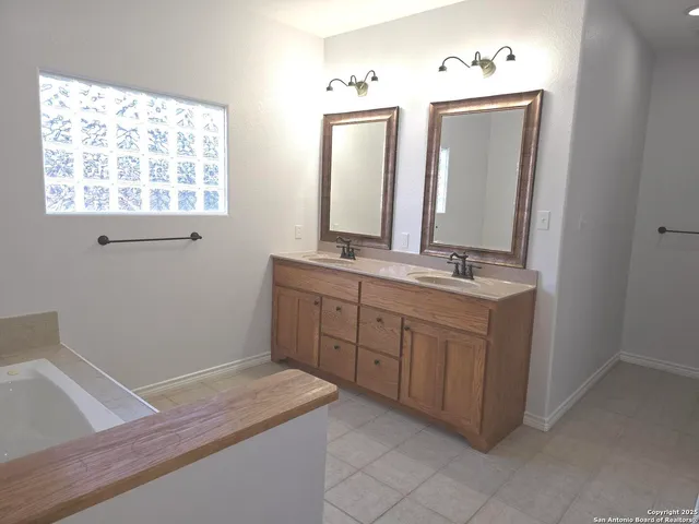 a bathroom with a sink vanity and mirror