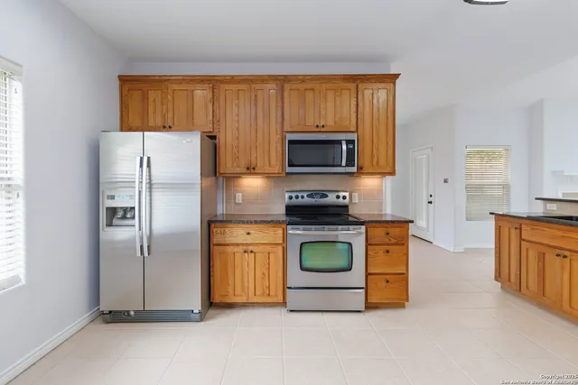 a kitchen with a refrigerator stove and microwave