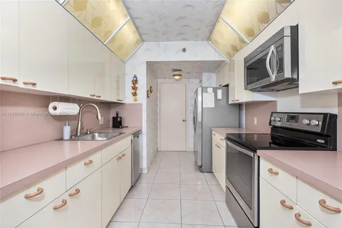 a kitchen with stainless steel appliances granite countertop a sink and a stove