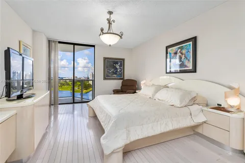 a spacious bedroom with a bed and a view of bedroom