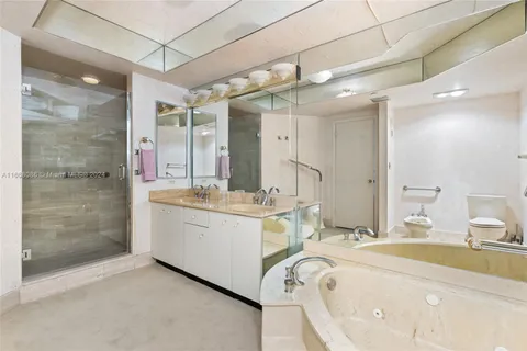 a bathroom with a granite countertop sink mirror and shower