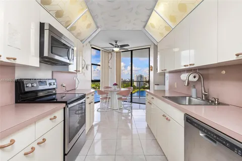 a kitchen with stainless steel appliances a sink stove and cabinets