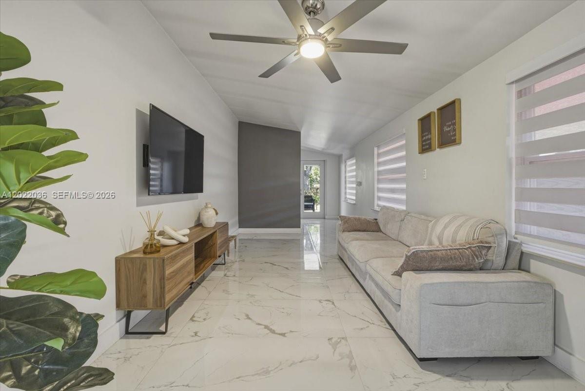 120 West 50th Street Hialeah, FL 33012 - Photo 7 of 22 a living room with furniture and a flat screen tv
