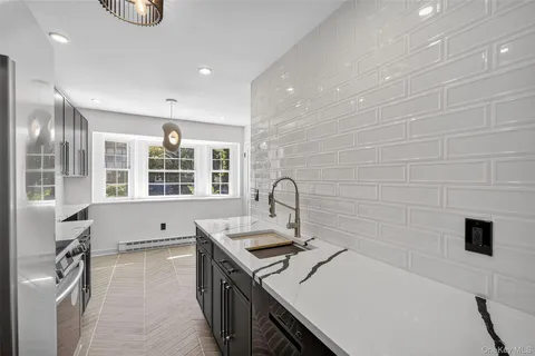 a kitchen with a sink and a stove top oven