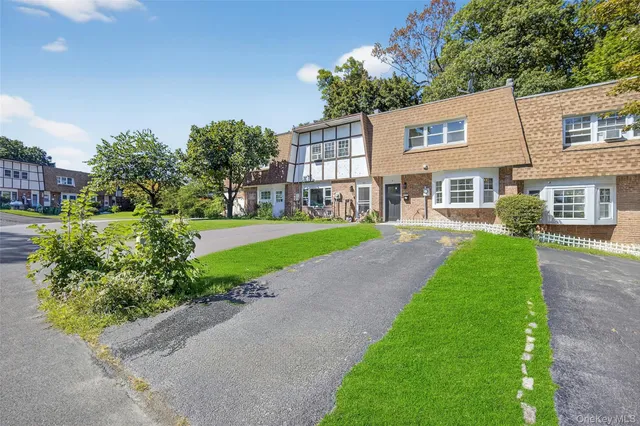 a front view of a house with a yard and outdoor seating