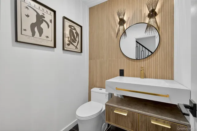 a bathroom with a toilet a sink and a mirror