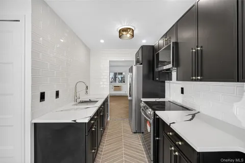 a kitchen with a sink refrigerator and microwave