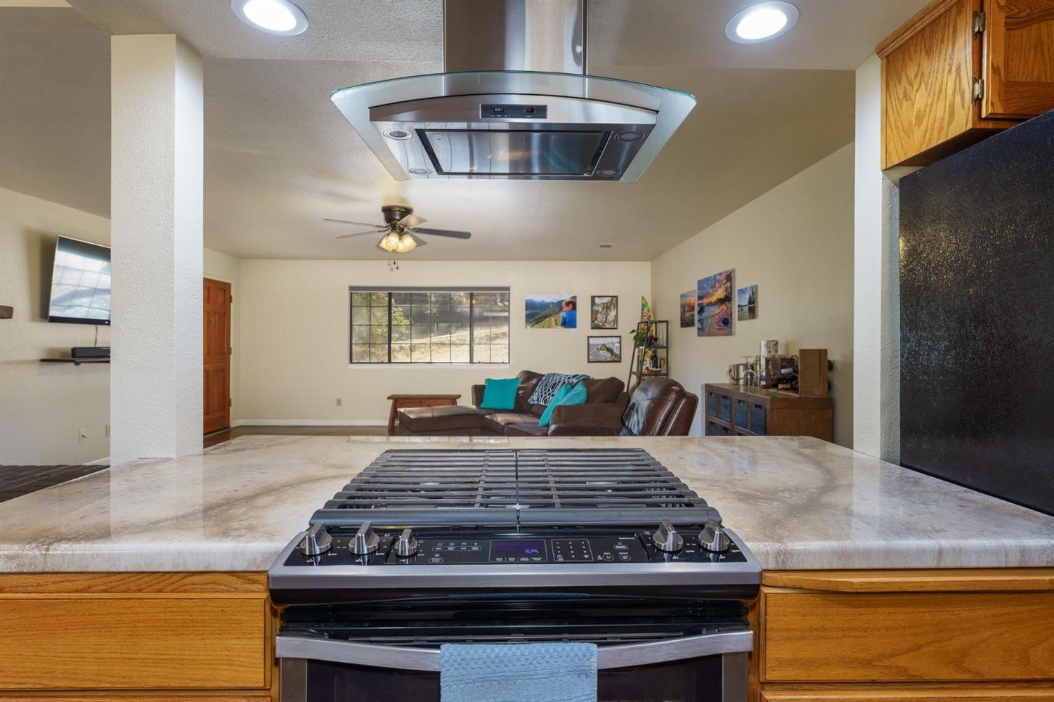 40410 Goldside Drive Oakhurst, CA 93644 - Photo 12 of 24 a kitchen with kitchen island a stove and a wooden floors
