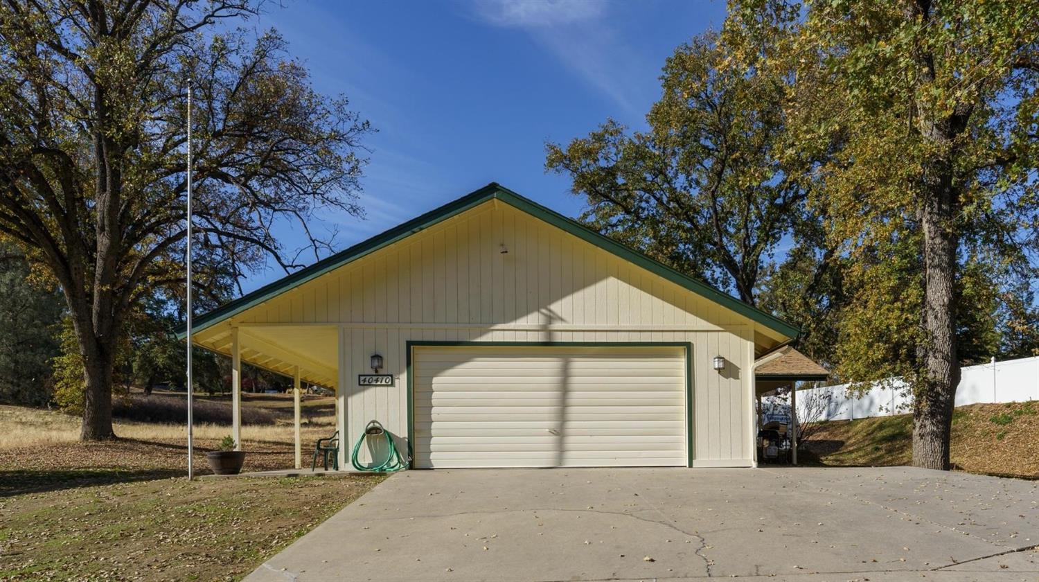 40410 Goldside Drive Oakhurst, CA 93644 - Photo 21 of 24 a view of a house with a yard and garage