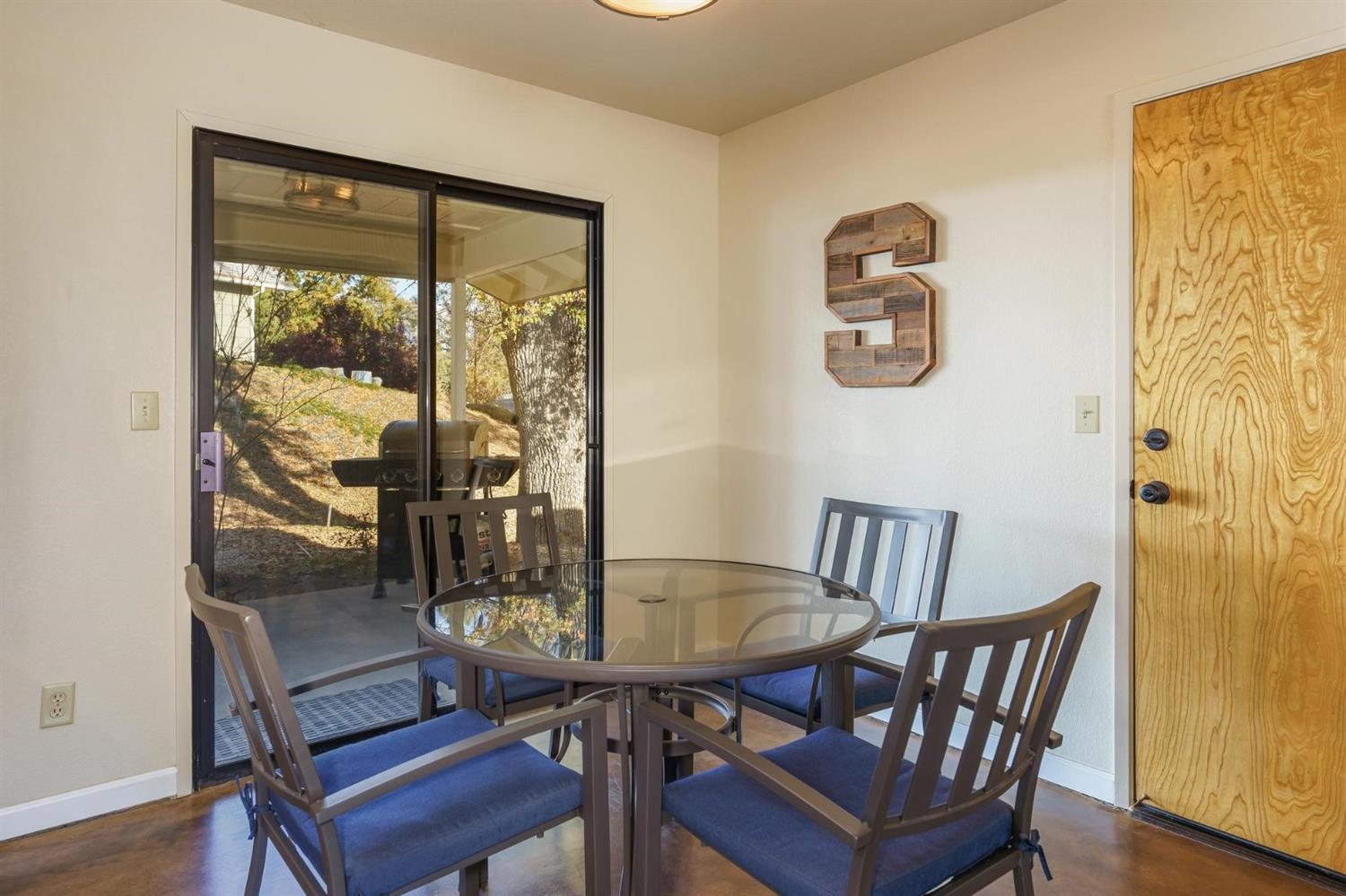 40410 Goldside Drive Oakhurst, CA 93644 - Photo 7 of 24 a view of a dining room with furniture window and wooden floor