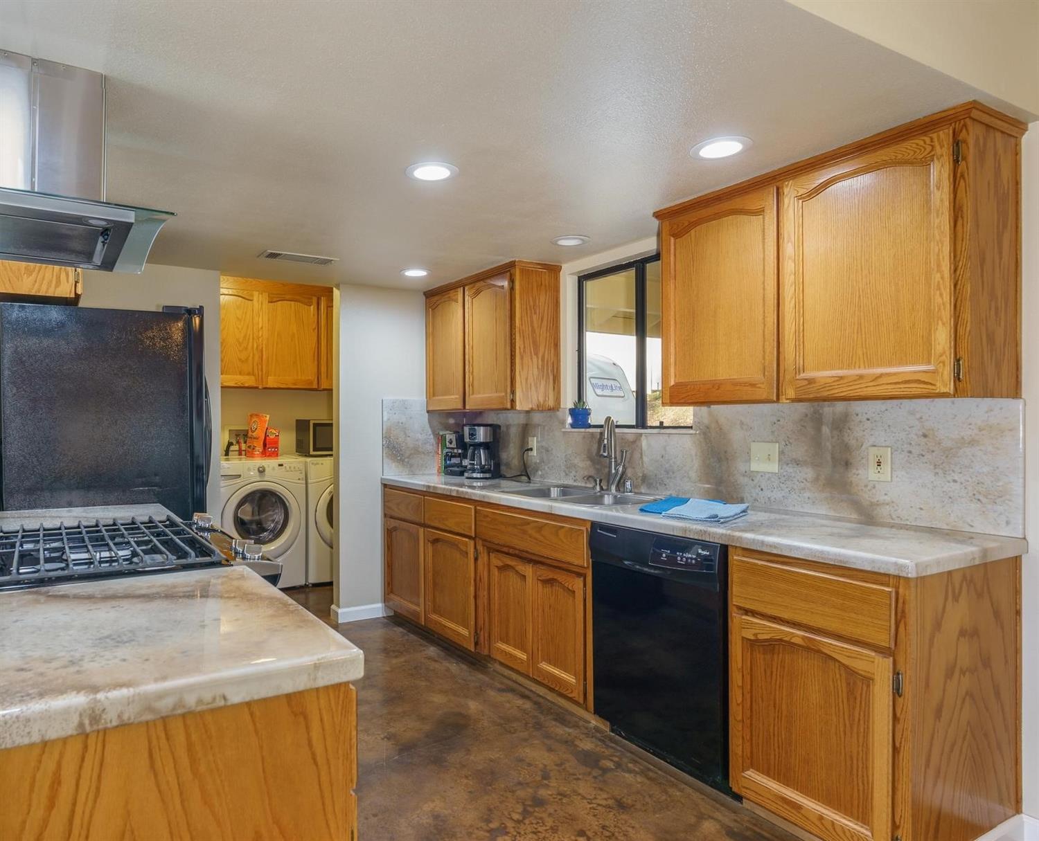 40410 Goldside Drive Oakhurst, CA 93644 - Photo 9 of 24 a kitchen with stainless steel appliances granite countertop sink stove top oven and cabinets