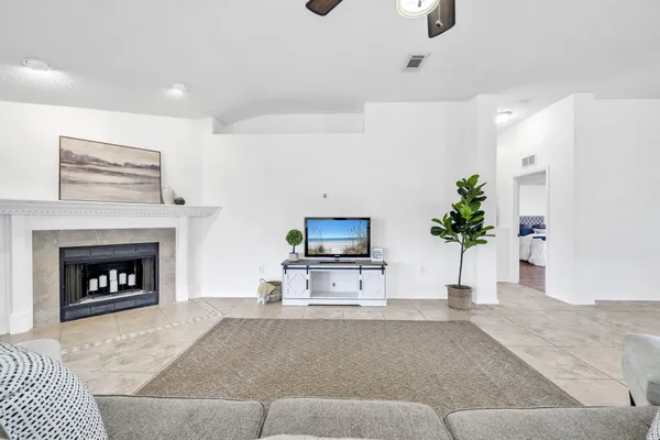 a kitchen with granite countertop a sink a stove top oven a counter space and cabinets