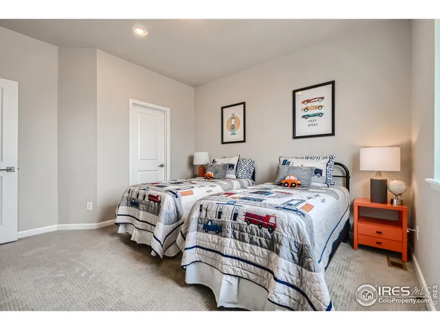 a bedroom with a bed and a lamp