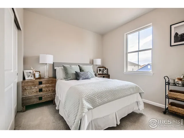 a spacious bedroom with a bed and a window