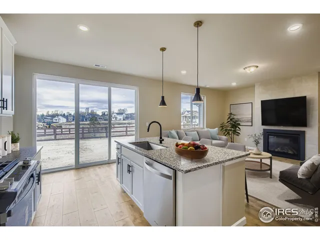 a living room with furniture a flat screen tv and a floor to ceiling window