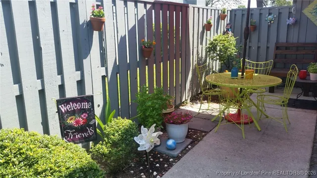 a view of a chairs and table in backyard