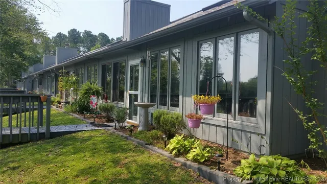 a view of a chair and tables in the backyard