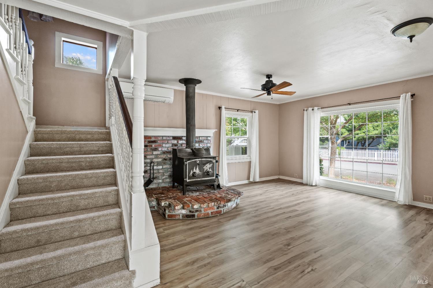 84 School Street Willits, CA 95490 - Photo 18 of 37 a view of a livingroom with wooden floor and a ceiling fan