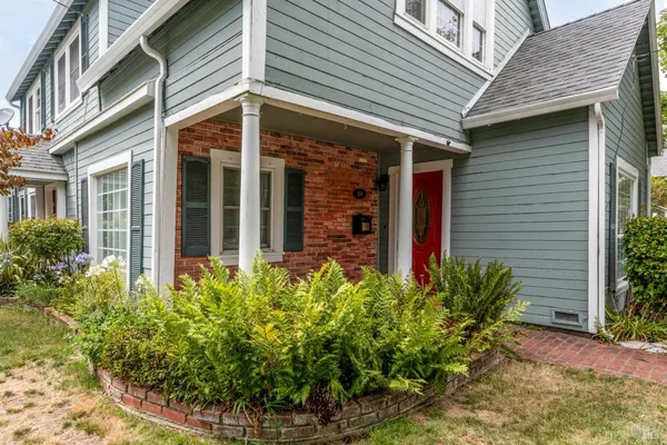 a view of a house with potted plants