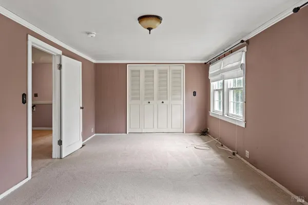 a view of an empty room with a window