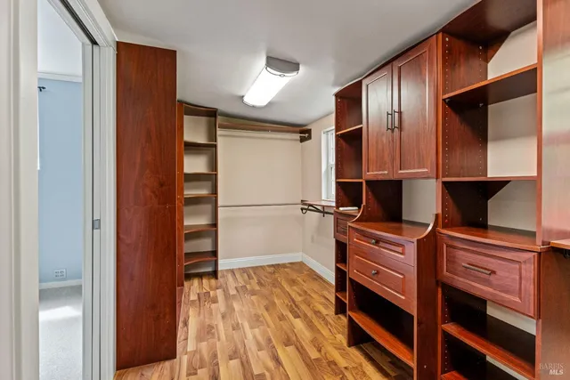 a kitchen with stainless steel appliances a refrigerator and wooden floor