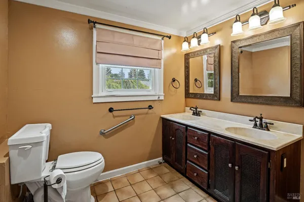 a bathroom with a toilet sink and mirror