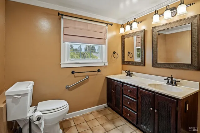 a bathroom with a toilet sink and mirror