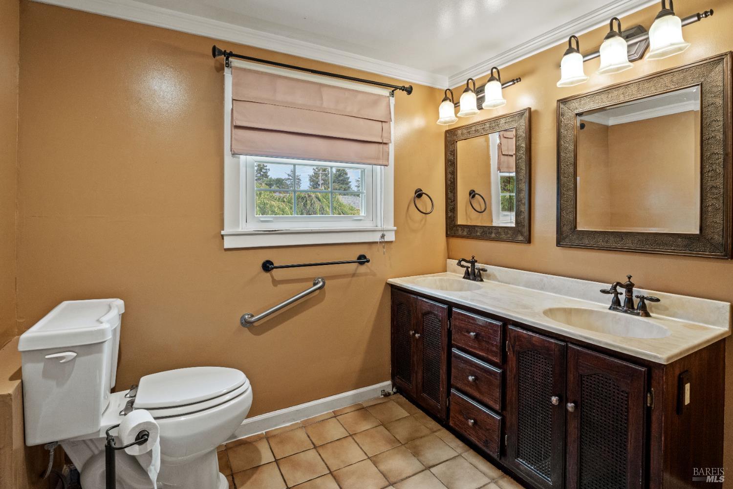 84 School Street Willits, CA 95490 - Photo 26 of 37 a bathroom with a toilet sink and mirror