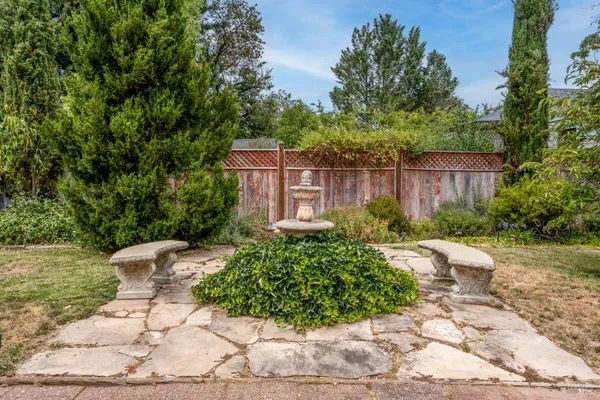 a view of a chair and table in the backyard