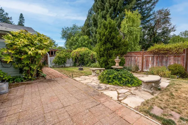 a view of a backyard with sitting area