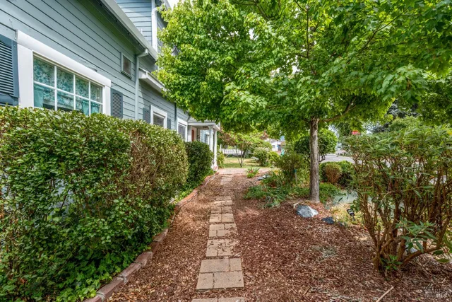 a view of a pathway both side of house