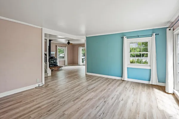 wooden floor in an empty room with a window