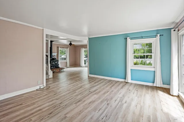 wooden floor in an empty room with a window