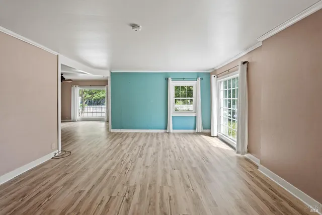 wooden floor in an empty room with a window