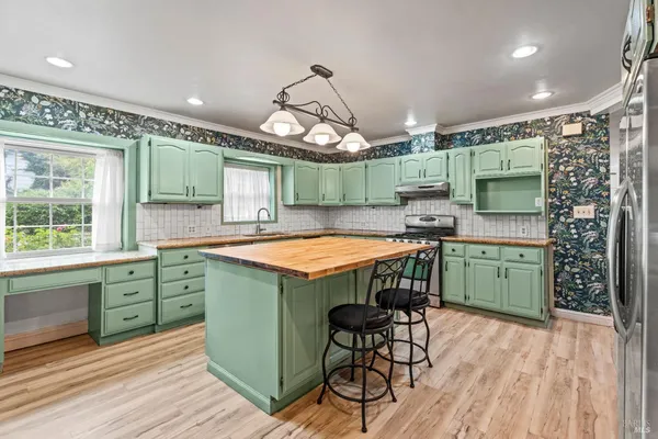 a kitchen with a sink a counter space and a window