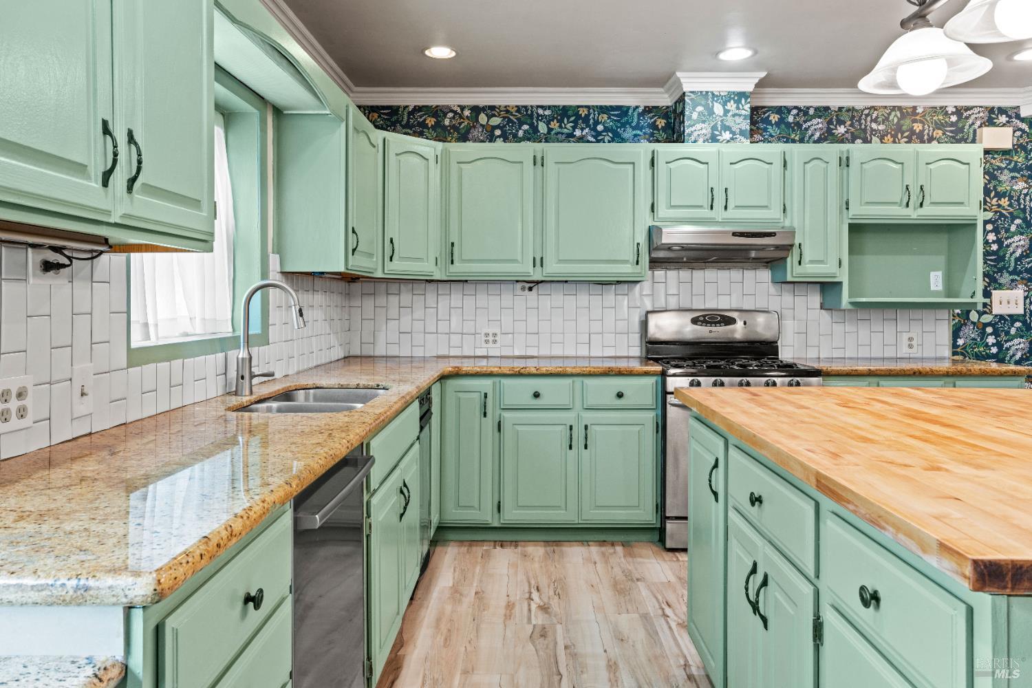 84 School Street Willits, CA 95490 - Photo 7 of 37 a kitchen with a sink a stove and cabinets
