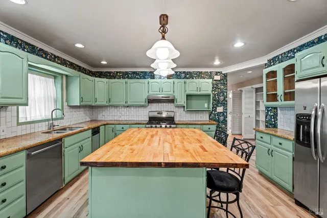 a large kitchen with stainless steel appliances granite countertop a stove and a sink