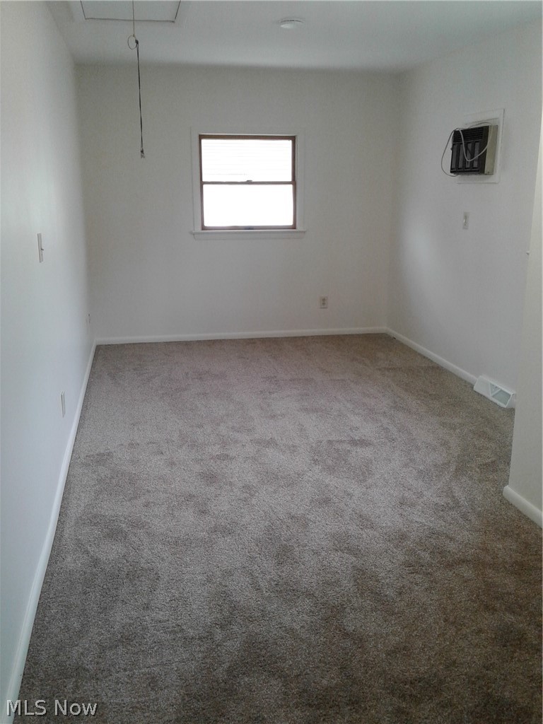 613 Jackson Street Amherst, OH 44001 - Photo 15 of 29 Primary Bedroom with attic access and new light carpet