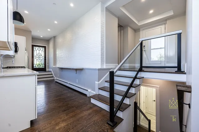 a view of entryway and hall with wooden floor