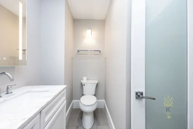 a bathroom with a granite countertop sink a mirror and a shower