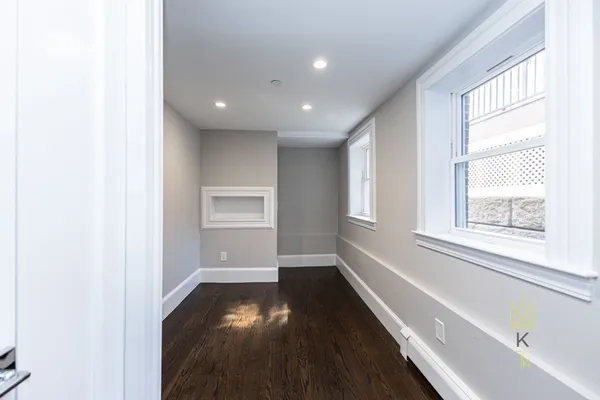 a view of a hallway with wooden floor
