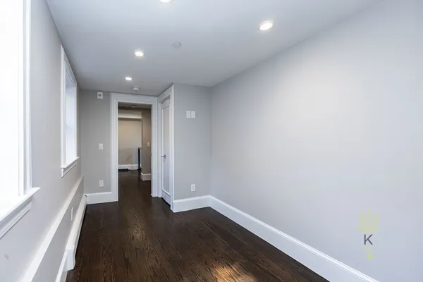 a view of hallway with wooden floor
