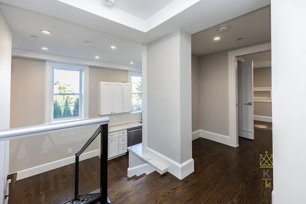 a view of a room with wooden floor and windows