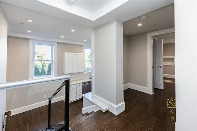 a view of a room with wooden floor and windows