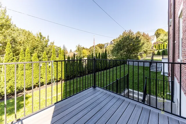 a view of balcony with wooden floor