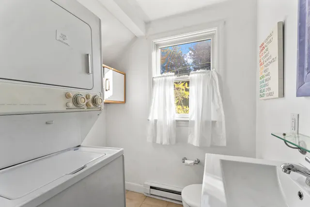 a view of a bedroom with wooden floor and a bed